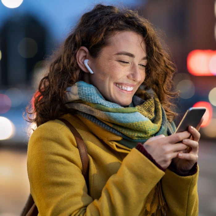 young woman smiling on her phone