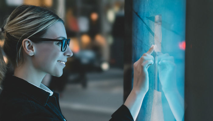 a woman using a digital touch screen