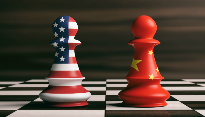 US America and China flags on chess pawns soldiers on a chessboard 