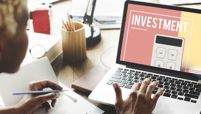 a woman looking at investments on a screen