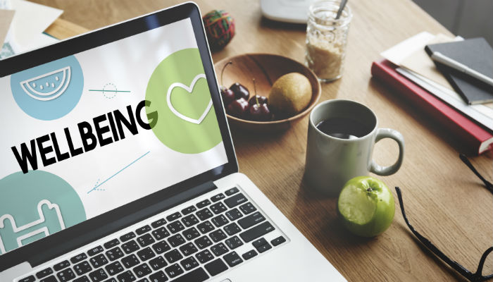 a laptop with the words wellbeing on the screen