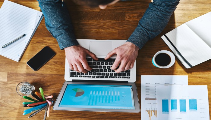 man on laptop working at a desk
