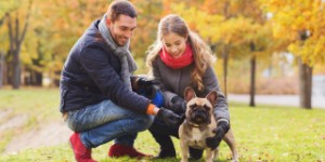 young couple with dog in park