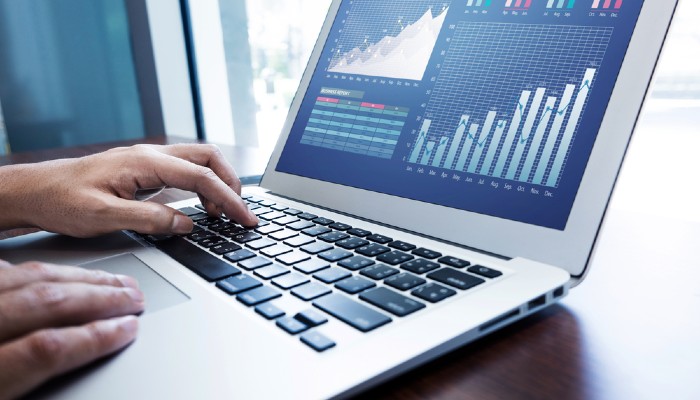 Person working on laptop with graphics on the screen