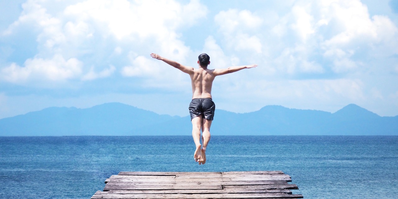 man jumping into the sea