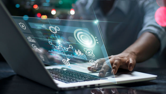 laptop analyzing information on futuristic virtual interface screen