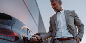man charging ev car