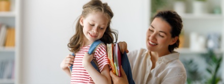 mother packing child school bag