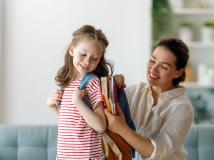 mother packing child school bag