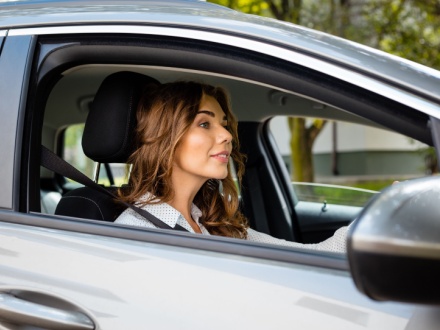 woman driving silver car