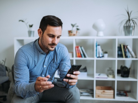 man at home on phone