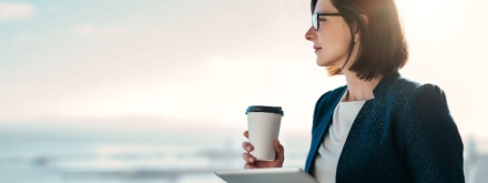 woman with coffee and tablet