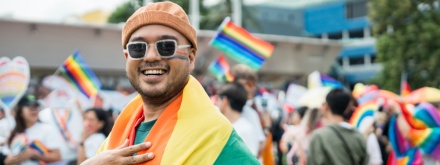 smiling man celebrating pride parade