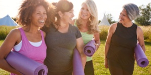 group of happy mature woman doing yoga