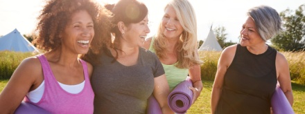 group of happy mature woman doing yoga