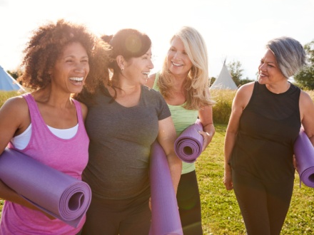 group of happy mature woman doing yoga