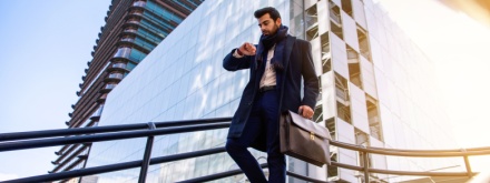 business man waking looking at watch