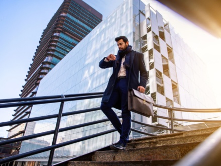 business man waking looking at watch