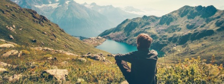hiker sitting down taking in mountain views
