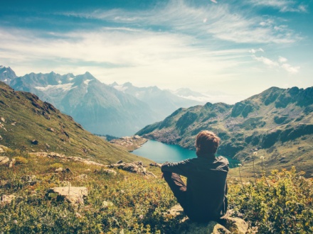 hiker sitting down taking in mountain views