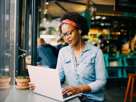 woman in coffee shop on laptop