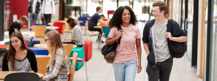 two college students walking in communal college area