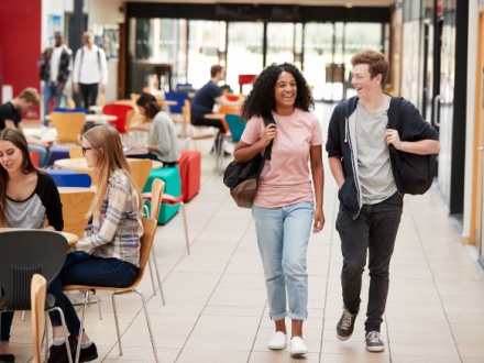 two college students walking in communal college area
