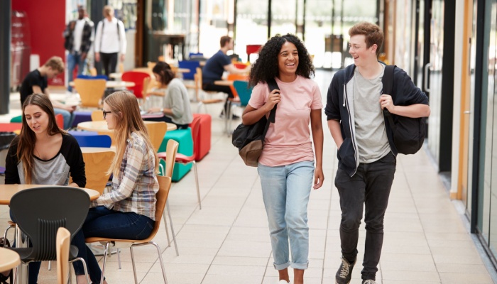 two college students walking in communal college area