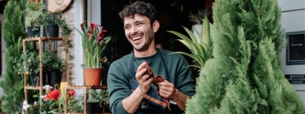 Smiling man outside a florist