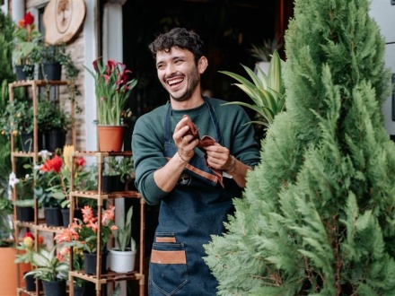 Smiling man outside a florist