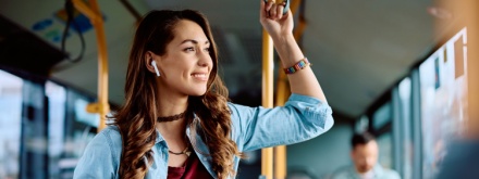 woman on public transport listening to music