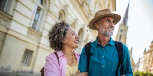 Middle aged couple on city break reading a map