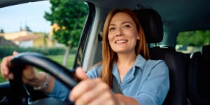 smiling woman driving car