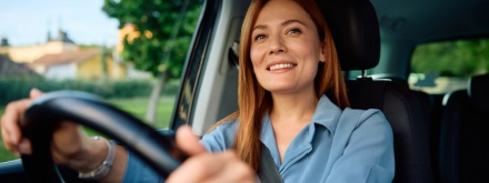 smiling woman driving car