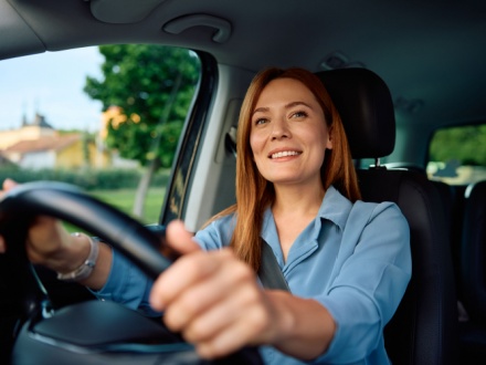smiling woman driving car