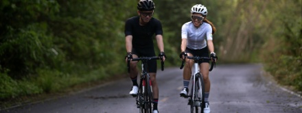 man and woman road cycling
