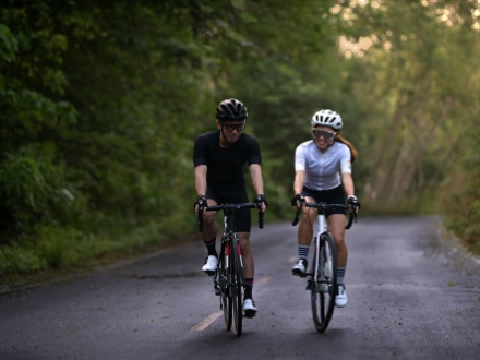 man and woman road cycling
