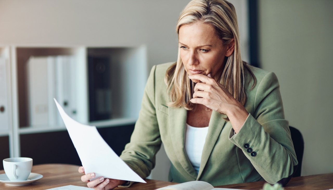 business woman doing paperwork at her desk