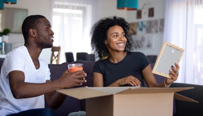 Man and woman unpacking boxes in new home