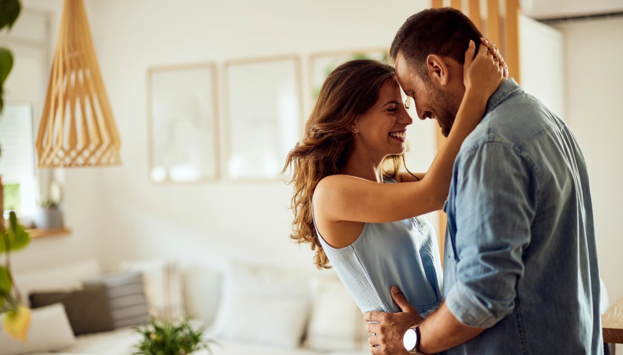 happy couple at home hugging