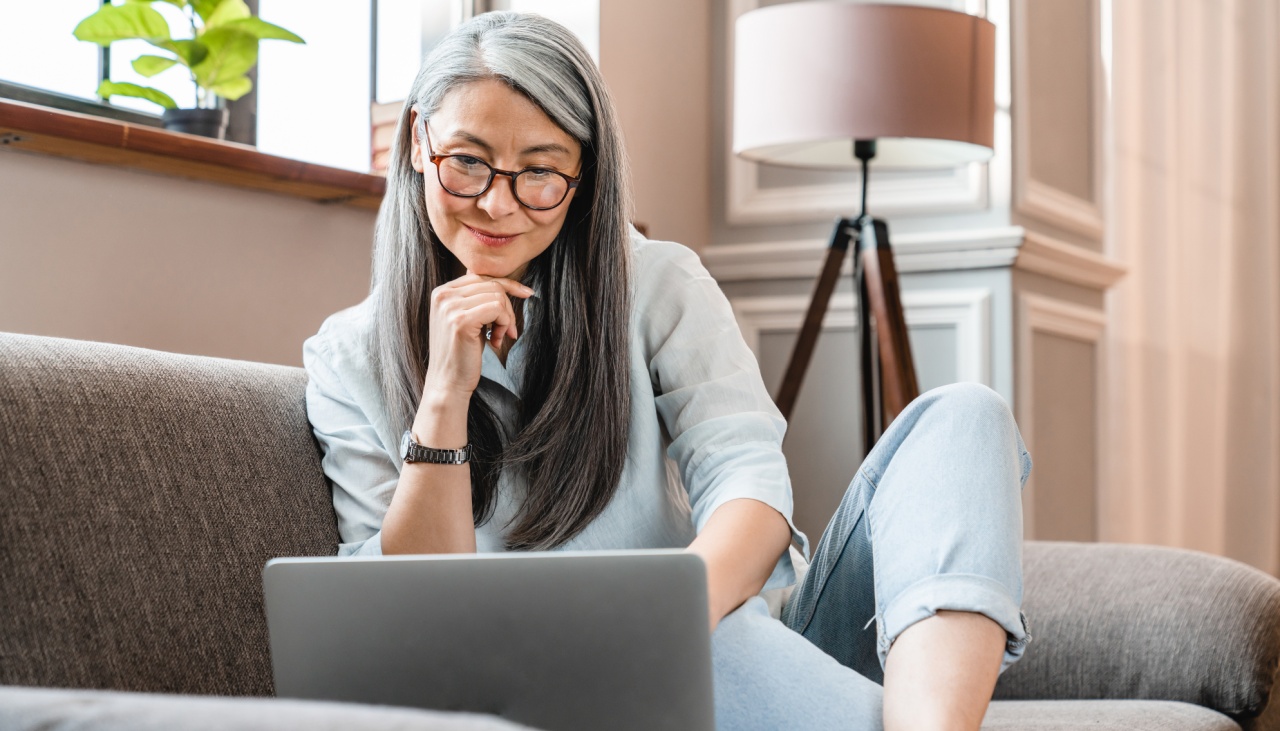 Woman with glasses looking at laptop