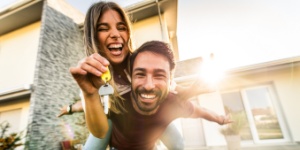 happy young couple holding home keys