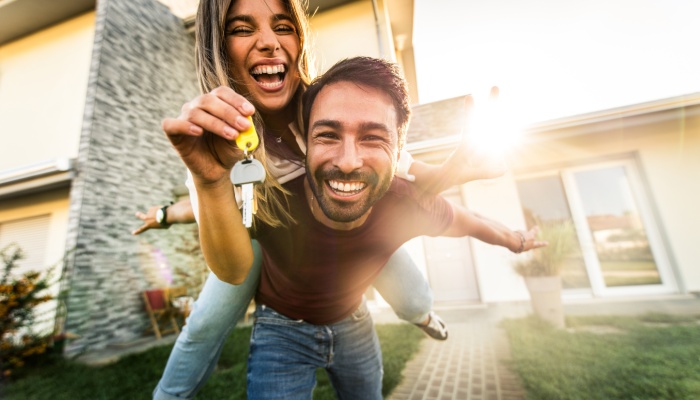 happy young couple holding home keys