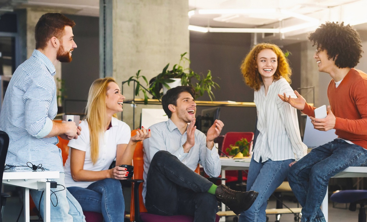 Group of happy office workers have coffee break together
