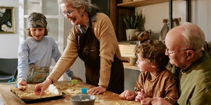 Grandparents cooking at home with grandchildren