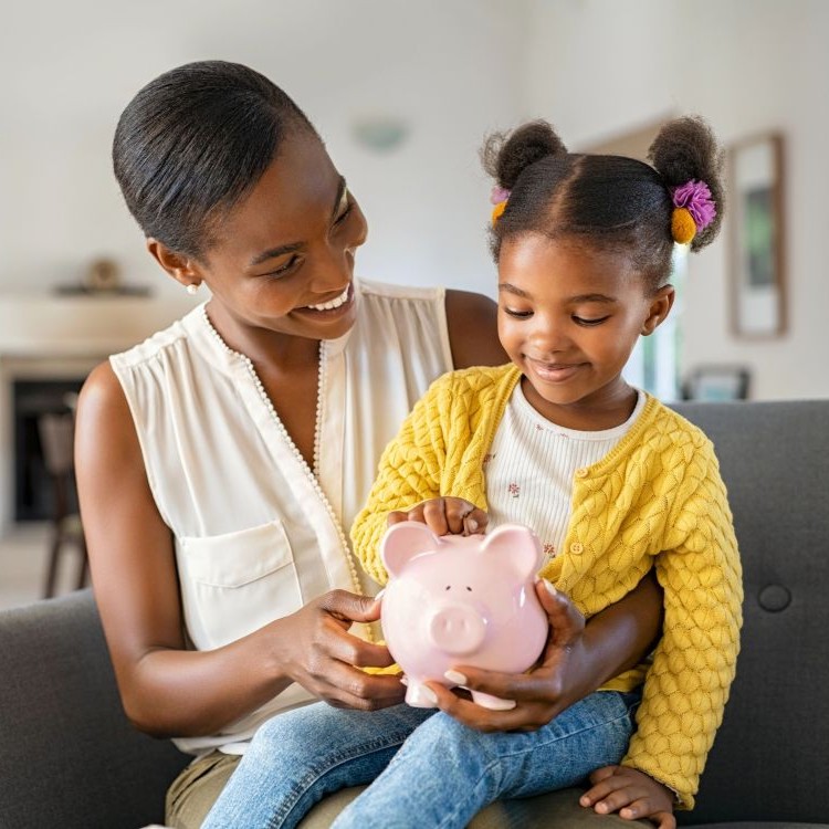 Young mum with daughter sitting on her lap at home