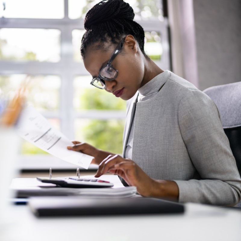 female in office on calculator