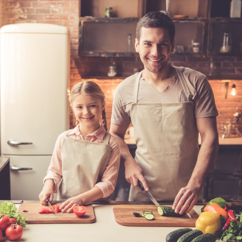 father and daughter cooking