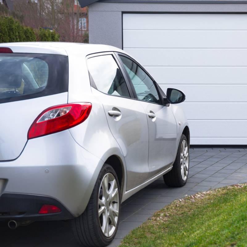 car in garden driveway