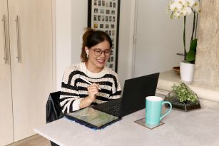 Woman working at desk on laptop